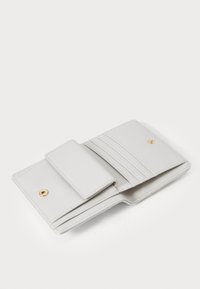 Light grey leather wallet, featuring a snap closure, multiple card slots, and a smooth texture with stitched accents.