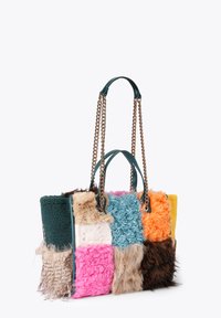 Torebka typu tote w wielokolorowym patchworku, wykonana z różnych teksturowanych tkanin, w tym futra i pluszu, z turkusowymi skórzanymi ramiączkami i złotymi akcentami w postaci łańcuszka.
