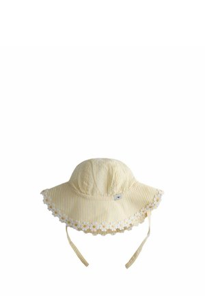 Pălărie de soare cu dungi galbene și albe, cu margine decorată cu flori de margarete de-a lungul borului larg și curele pentru bărbie pentru fixarea pălăriei.
