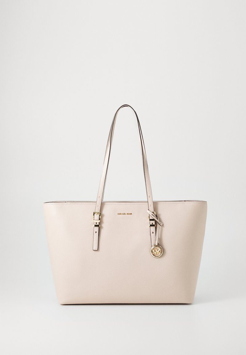 Beige leather tote bag with two top handles, a gold logo accent, and a textured finish. Features buckle details on handles.