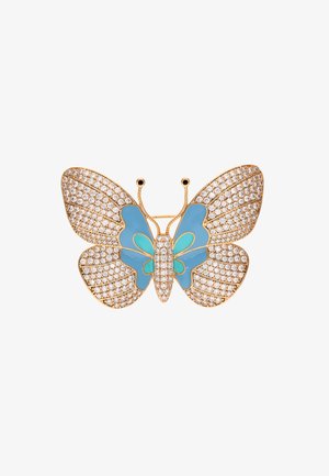 Kultainen perhosepistoke, jossa on kristallilla koristellut siivet, joissa on vaaleansinisiä emalikorostuksia ja monimutkaista metallityötä.