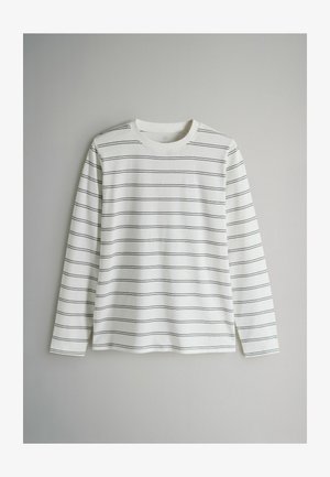 Pika varrukaga valge puuvillane särk, millel on õhukesed mustad horisontaalsed triibud, ümmargune kaelus ja lõdvestunud lõige, ilma nähtavate riistvara või aksessuaarideta.