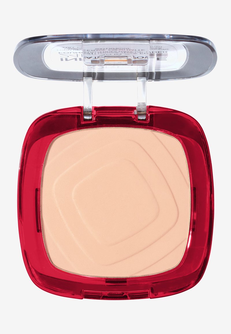 Poudre compacte avec un boîtier en plastique rouge, un couvercle transparent et un intérieur de poudre beige lisse présentant un motif géométrique.