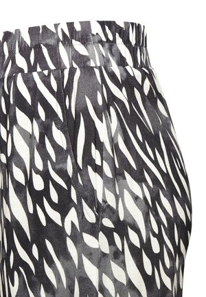 Black and white abstract zebra-print fabric with gathered elastic waistband and side seam pocket on a garment.