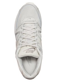 White athletic shoe with mesh and synthetic upper, padded tongue, round laces, and embossed Nike logo on the toe.