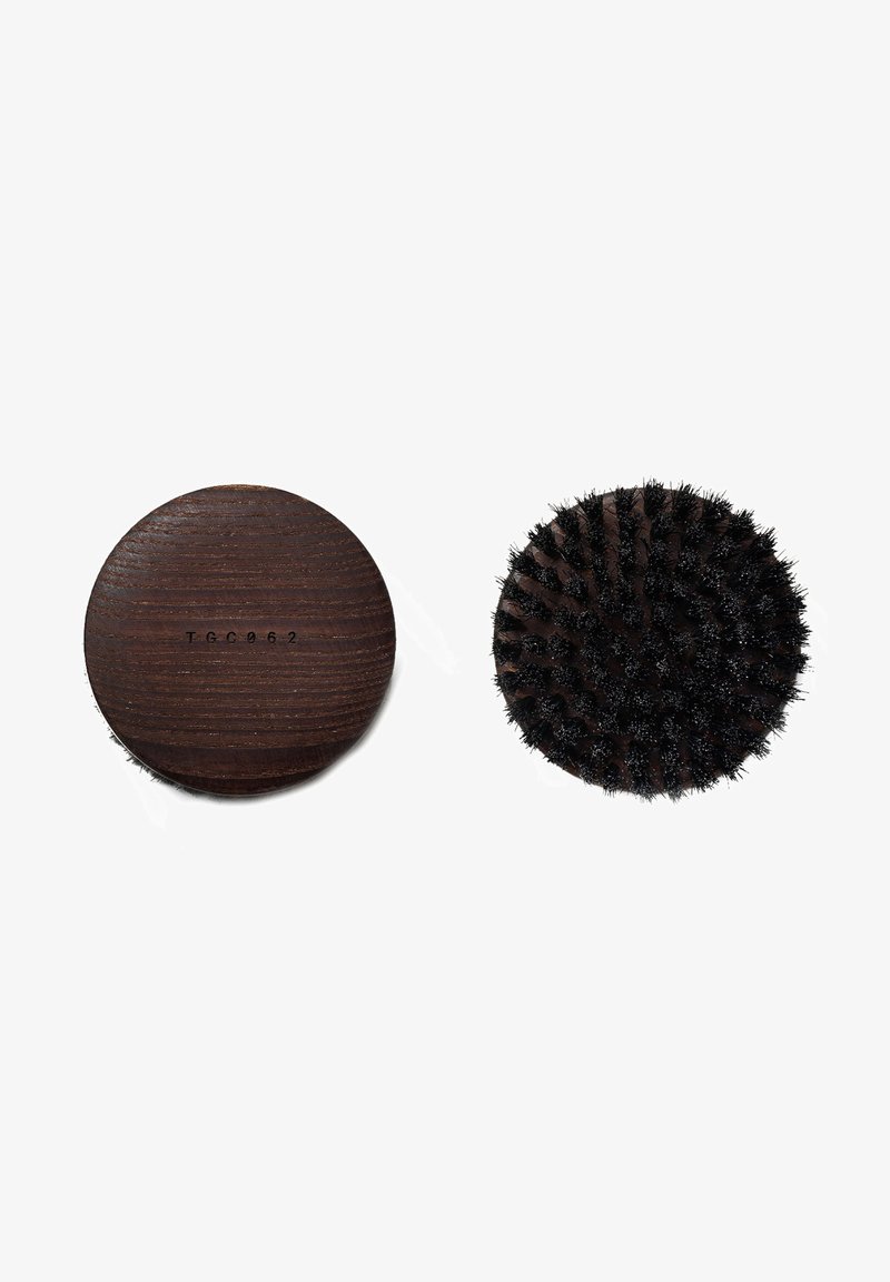 Wooden hairbrush with a dark finish, featuring a rounded handle and dense black bristles arranged in a circular pattern.