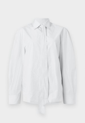 White, long-sleeve shirt with a classic collar and an elongated front tie. Made of smooth fabric, featuring a relaxed fit and no patterns.