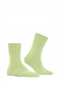 Chaussettes en mélange de coton vert clair avec une bande côtelée et une texture lisse, arborant un logo bleu sur le c ôté.