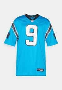 Carolina Panthers mez, kék anyag, rövid ujjú, nagy fehér 9-es szám, fekete díszítések az ujjakon, NFL és Nike címkék az alján.