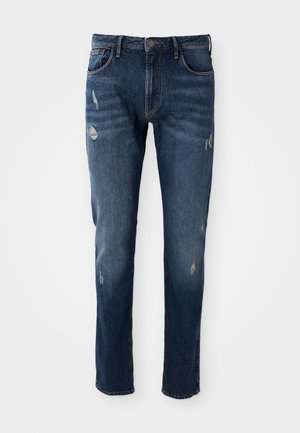 Dark blue denim jeans with slim fit, slight distressing on thighs and knees, classic five-pocket design, and button closure.