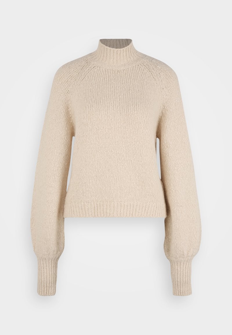Beżowy sweter dzianinowy z wysokim kołnierzem, raglanowymi rękawami i prążkowanymi mankietami. Miękka struktura z luźnym krojem i długością do połowy brzucha.
