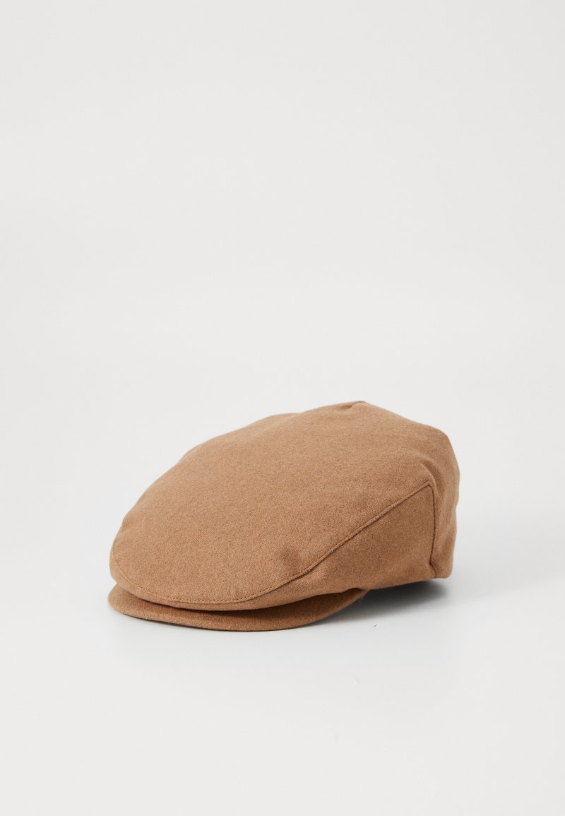 Casquette en laine marron au format arrondi, avec une visière plate et des détails cousus sur le côté. Texture douce et design minimaliste.