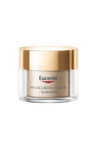 Eucerin Hyaluron-Filler-Glas mit transparentem Boden und goldenem Deckel. Das Etikett enthält "Hyaluron-Filler + Elastizität" in rotem und schwarzem Text.