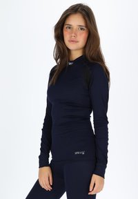 Langmouw, aansluitend navy bovenstuk van ribbelstof met zwarte accenten. Heeft een ronde hals en het COOLMAX® logo aan de zoom.