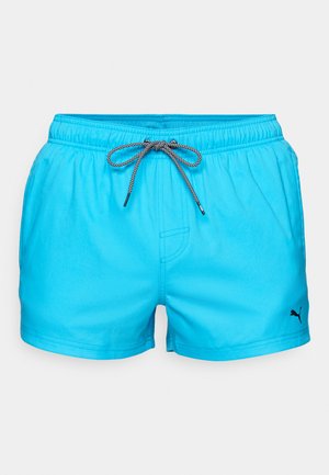 Light blue swim shorts made of quick-drying fabric, featuring an elastic waistband with a black drawstring and a small black logo on the side.