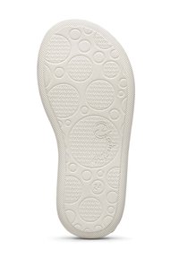 Bílá gumová podešev boty se zaoblenými texturami a vlnitým vzorem, s vyraženým logem a velikostí číslo "24". Texturované okraje.