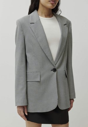 Grau und schwarzer kariertes Blazer mit einem Ein-Knopf-Verschluss, Reverskragen und zwei vorderen Taschen. Texturiert mit einer taillierten Passform.
