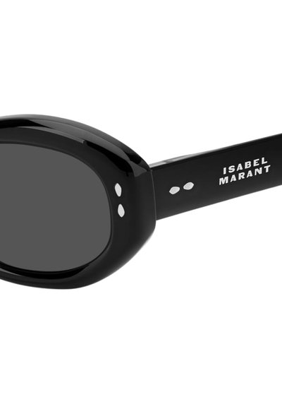 Occhiali da sole ovali neri con lenti scure e puntini decorativi bianchi vicino alla cerniera, con il logo Isabel Marant sull'asta laterale.