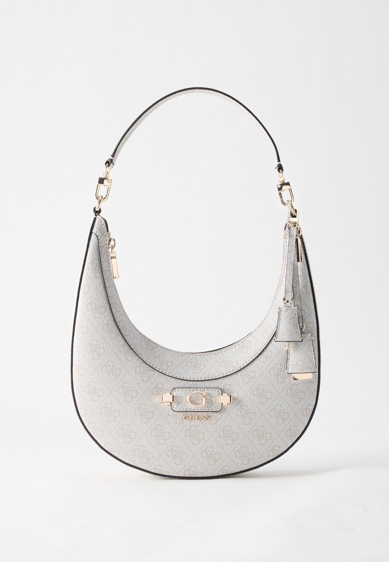 Sac à main gris clair en forme de croissant avec motif monogramme, ferrures dorées, bandoulière courte et étiquettes décoratives pendantes.