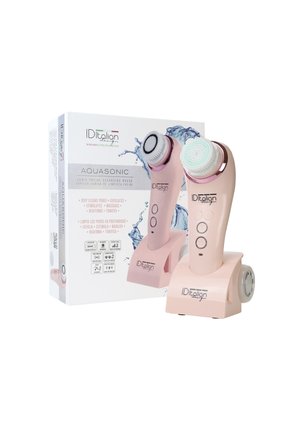 Cepillo de limpieza facial con dos cabezales de cepillo desmontables, colocado sobre una base de carga junto a su caja de producto con gráficos de salpicaduras de agua.
