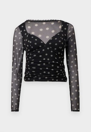 Musta pitkähihaine paita, joka on valmistettu läpikuultavasta materiaalista ja jossa on valkoisia pilkkuja, rypytetty vartalo ja aallotettu päärme. Tiukasti istuva malli.