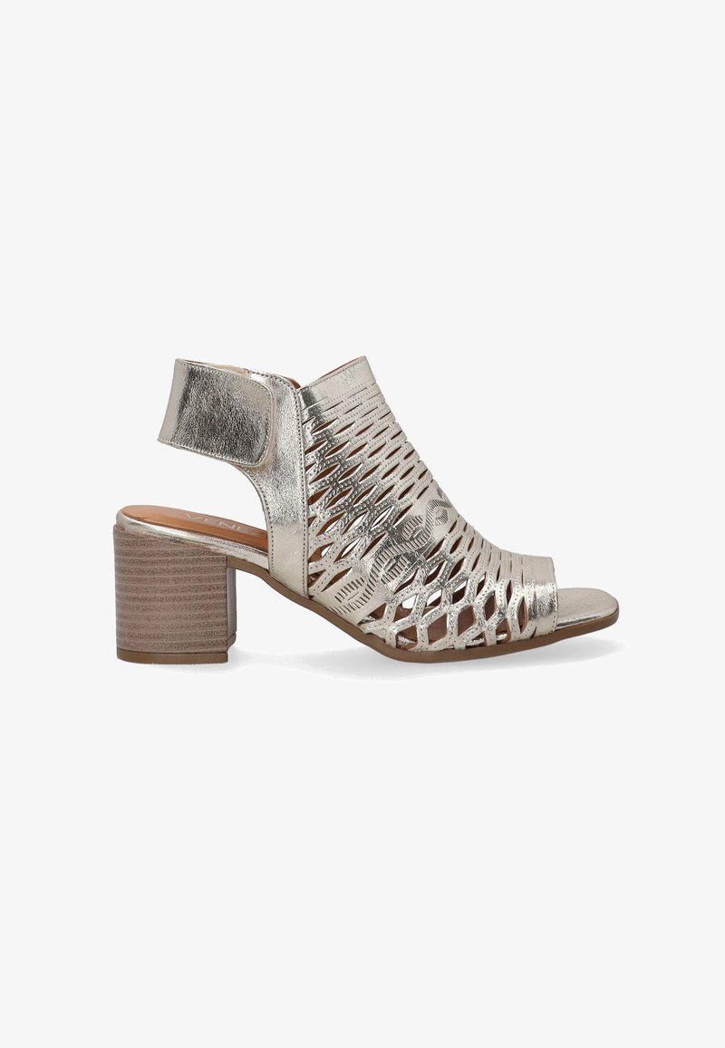 Metallic silver open-toe shoe with cutout design, ankle strap, and a chunky wooden heel. Textured surface and smooth interior.