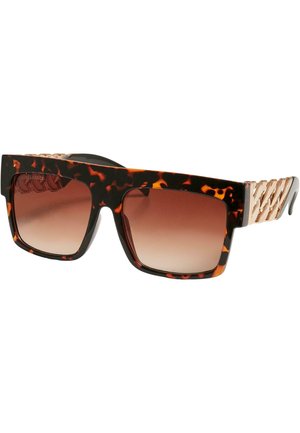 Lunettes de soleil en écaille de tortue avec des montures carrées, des verres bruns dégradés et un accent métallique doré sur les branches. Surface texturée sur la monture.