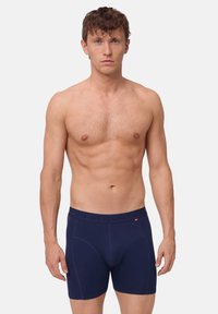 Marine blauwe boxershorts van een zachte, rekbare stof. Kenmerkt zich door een logoband in de taille en een aansluitend ontwerp met een soepele textuur.