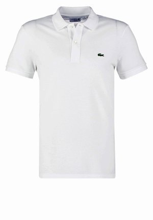 White polo shirt made of cotton, featuring a three-button placket, short sleeves, and a green embroidered crocodile logo on the left chest.