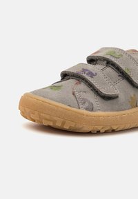 Gray suede children's shoe with two Velcro straps, featuring colorful animal patterns. Rubber sole with textured tread for grip.