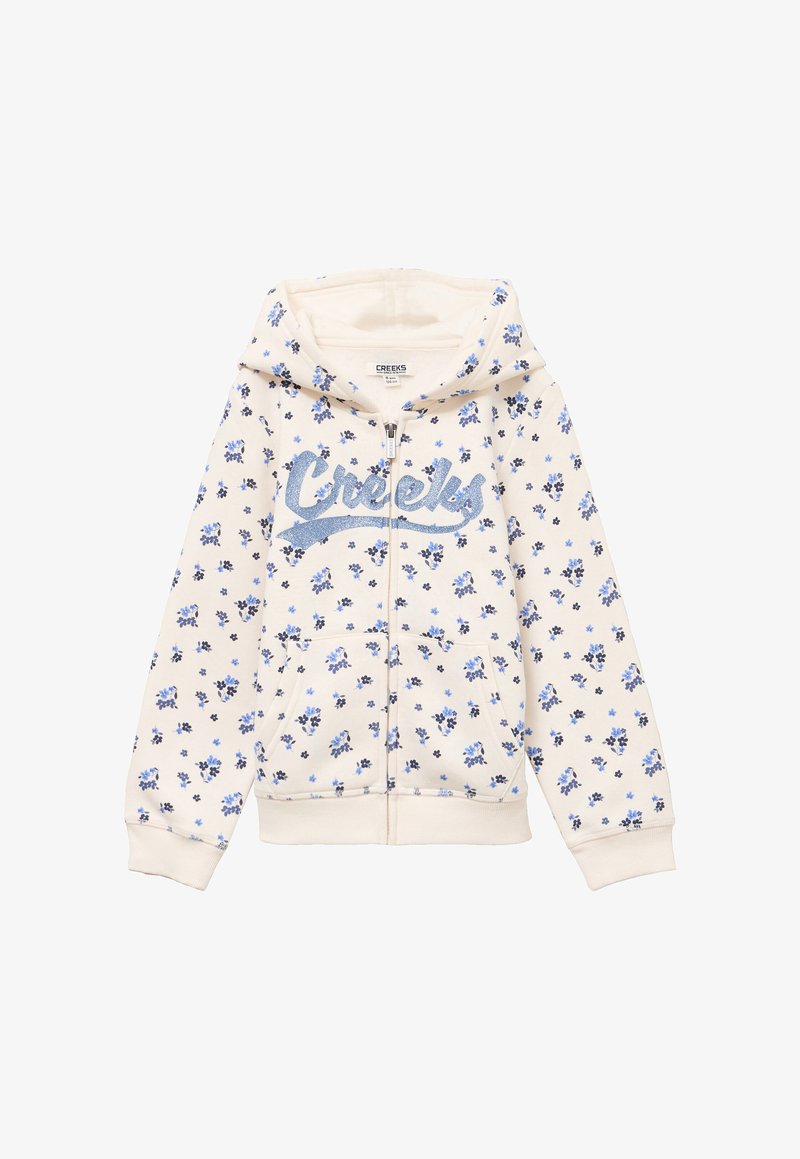 Sweat à capuche crème avec motif floral bleu, fermeture éclair devant, poches kangourou, et texte scintillant "Creeks" sur la poitrine.