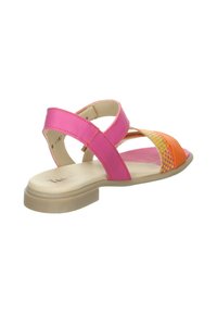 Rosa Leder-Sandalette mit Kreuzriemen, die ein mehrfarbiges Gewebe-Muster an der Zehenpartie aufweist. Flache Sohle mit einem leichten, transparenten Boden.