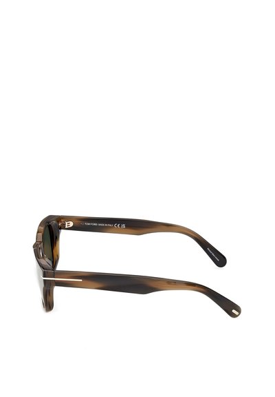 Tortoiseshell-patterned sunglasses with thick arms, subtle silver accents, and markings inside one arm indicating brand and origin.