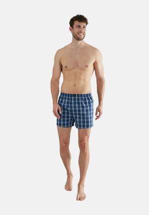 Boxer shorts in navy blue with a plaid pattern in shades of blue and white. Made from a soft fabric with an elastic waistband.