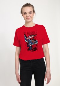 Red cotton t-shirt featuring a graphic print of a superhero in action, with text "Captain America" and "Brave New World" in bold lettering.
