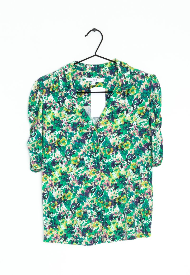 Short-sleeved floral blouse with a green, yellow, and purple pattern. Features a collar and buttons down the front. Lightweight fabric.
