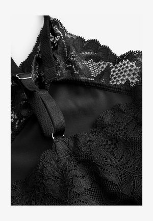 Schwarzer Spitzen-Bralette mit floralen Mustern, einem glatten Stoffuntergrund, verstellbaren Trägern und einem detaillierten Spitzenbesatz entlang des Ausschnitts.