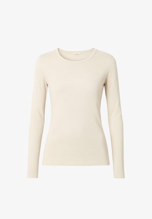 Top beige a maniche lunghe realizzato in tessuto morbido, con scollatura rotonda e design aderente. La cucitura senza soluzione di continuità lungo i bordi esalta la silhouette.