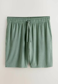 Shorts homme vert clair avec taille élastique et cordon, avec poches latérales, posés à plat sur un fond clair.