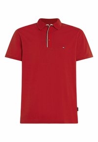Czerwona koszulka polo z bawełny. Posiada tradycyjny kołnierzyk, krótkie rękawy oraz kontrastowe białe i czarne wykończenia wzdłuż listwy guzikowej.