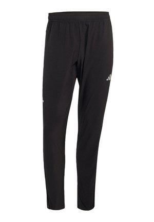 Pantalones deportivos negros con cintura elástica, corte slim que se estrecha en los tobillos y un pequeño logo blanco de Adidas en la parte superior del muslo.