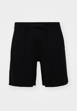 Pantaloni corti neri per bambini realizzati in un tessuto morbido, dotati di una cintura elastica con fiocco e orlo a costine. Design semplice senza decorazioni.