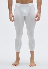 Λευκά αθλητικά κολάν με στενή εφαρμογή, που διαθέτουν ελαστική μέση με επωνυμία και ομαλό, ελαφρύ υλικό.