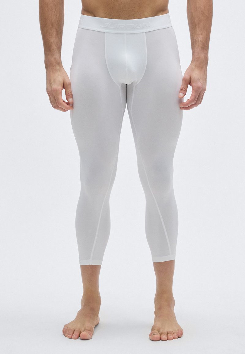 Λευκά αθλητικά κολάν με στενή εφαρμογή, που διαθέτουν ελαστική μέση με επωνυμία και ομαλό, ελαφρύ υλικό.