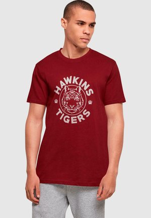 Maroon cotton t-shirt featuring a graphic of a tiger's face with the text "HAWKINS TIGERS" in gray, short sleeves, and a round neckline.