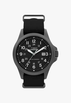 Timex Expedition ura na solarni pogon z mat črnim ohišjem, črnim številčnicam, velikimi belimi številkami in teksturiranim črnim najlonskim trakom.