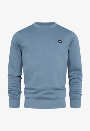 Niebieska bawełniana bluza z okrągłym dekoltem, długimi rękawami oraz ściągaczami przy mankietach i u dołu; posiada małe czarne logo na piersi.