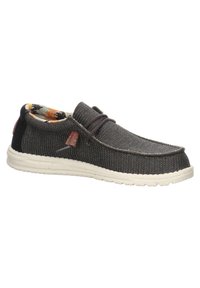 Scarpa slip-on in tessuto grigio con superficie texture, suola in gomma bianca e fodera a motivo nei toni di arancione e blu. Presenta un'etichetta decorativa.