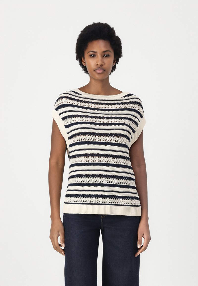 Strikket kortermet topp med horisontale striper i marineblått og krem, åpen arbeid detaljer og bred hals. Kombinert med mørke denimbukser.