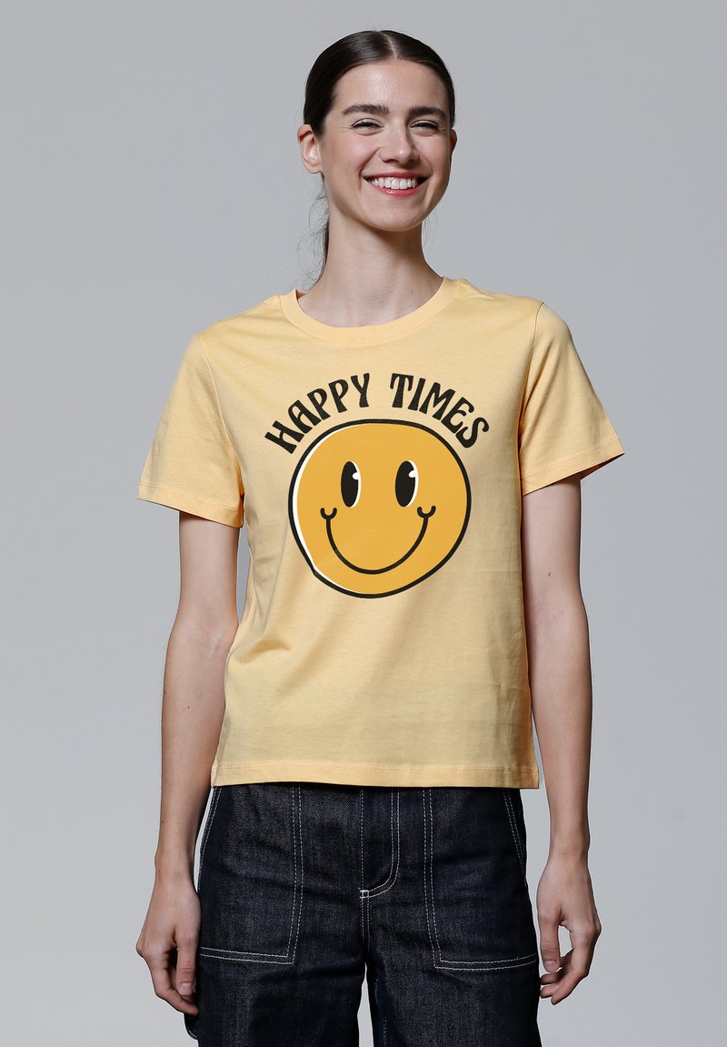 Geel katoenen T-shirt met een ronde smiley face grafiek en de tekst "HAPPY TIMES" in het zwart, korte mouwen en een relaxte pasvorm.